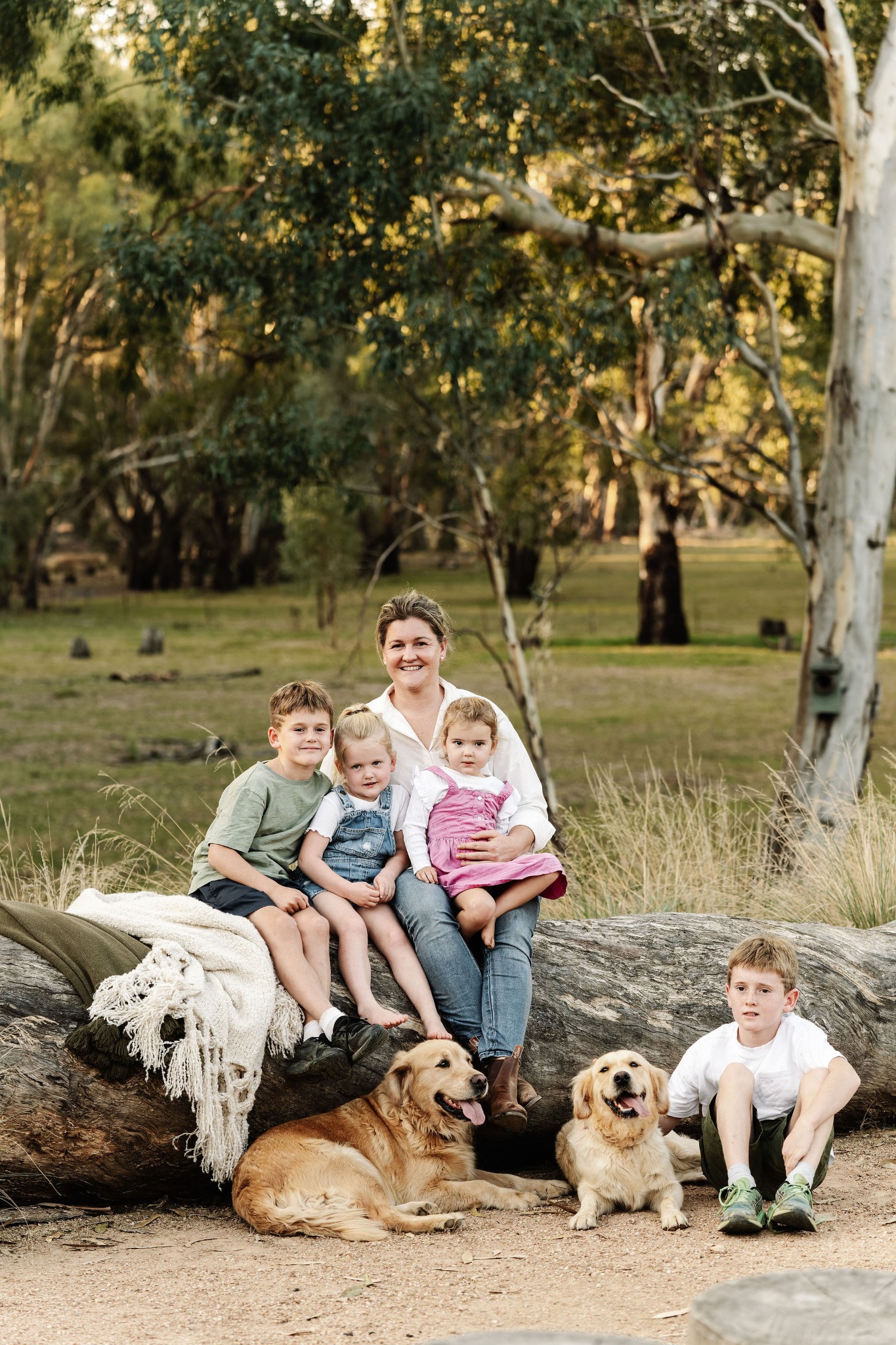 Kait Cummins with her children and dogs outdoors at Quondong